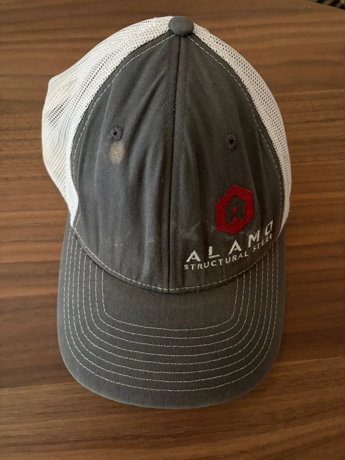 Retired gray and white Alamo Structural Steel trucker hat with red hexagon logo