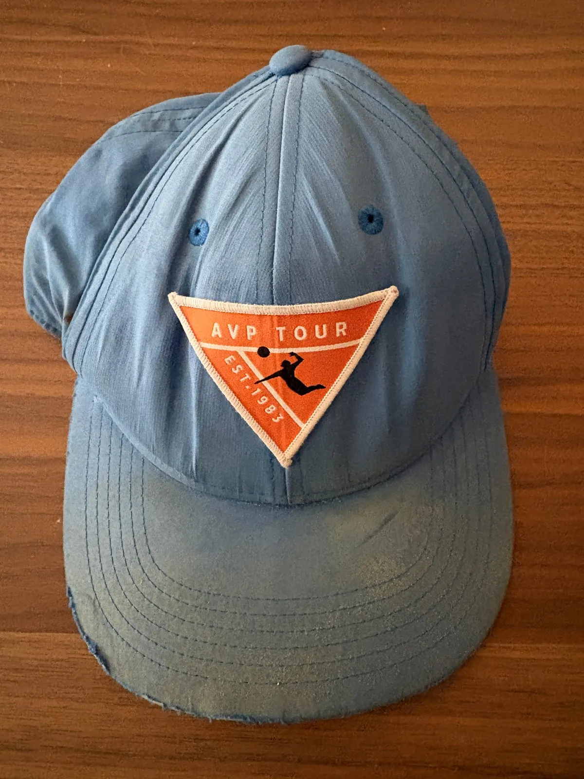Retired light blue AVP Tour cap with orange triangular patch