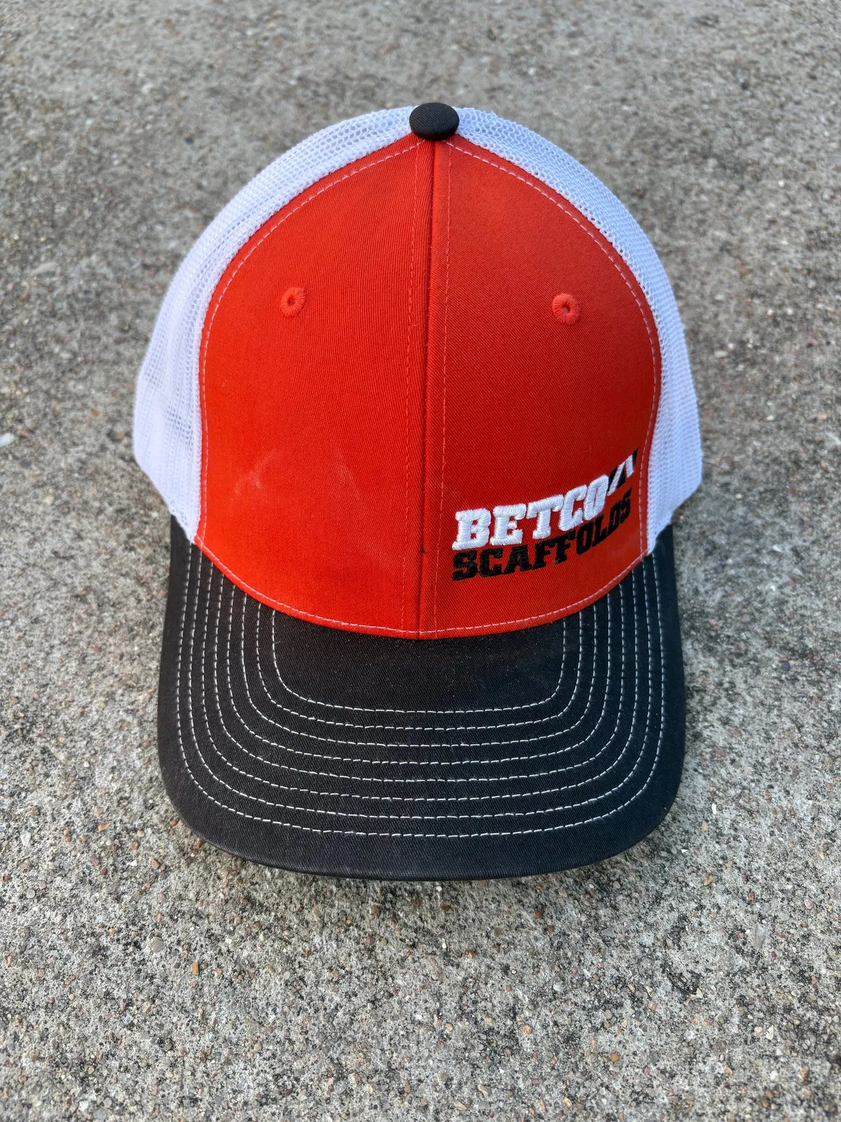 Retired orange Betco Scaffolds trucker hat with black brim