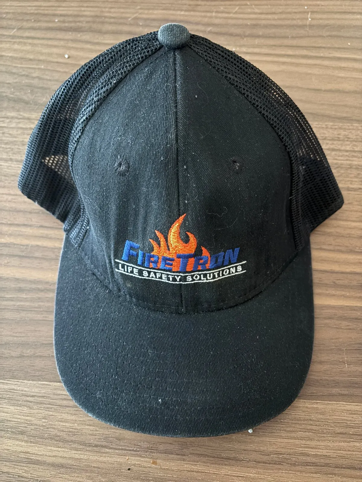 Retired black FireTron trucker hat with orange flame logo