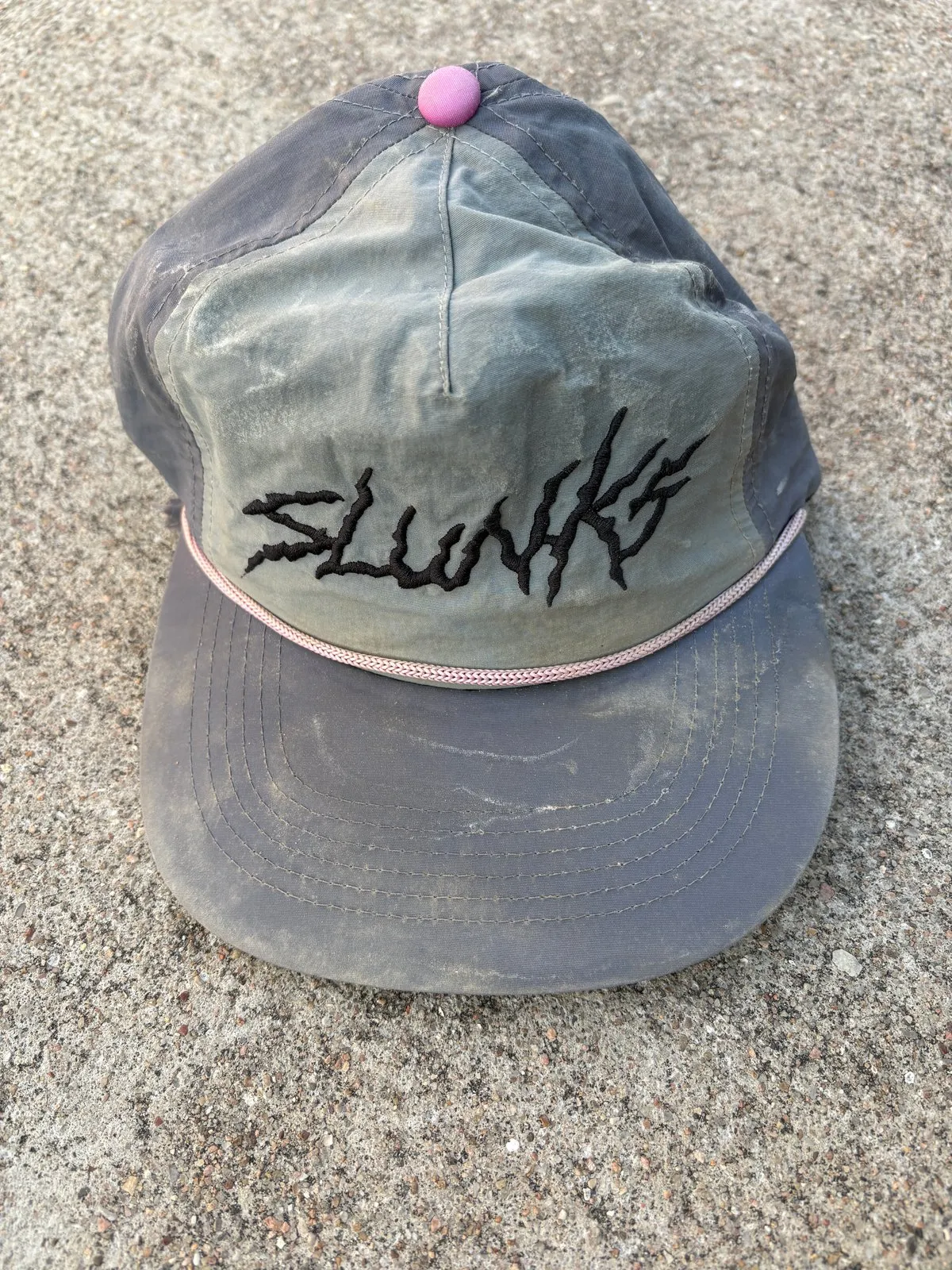 Retired grey Slunks cap with pink accents
